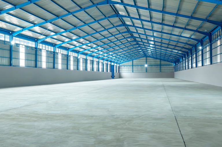Large warehouse interior with concrete floor